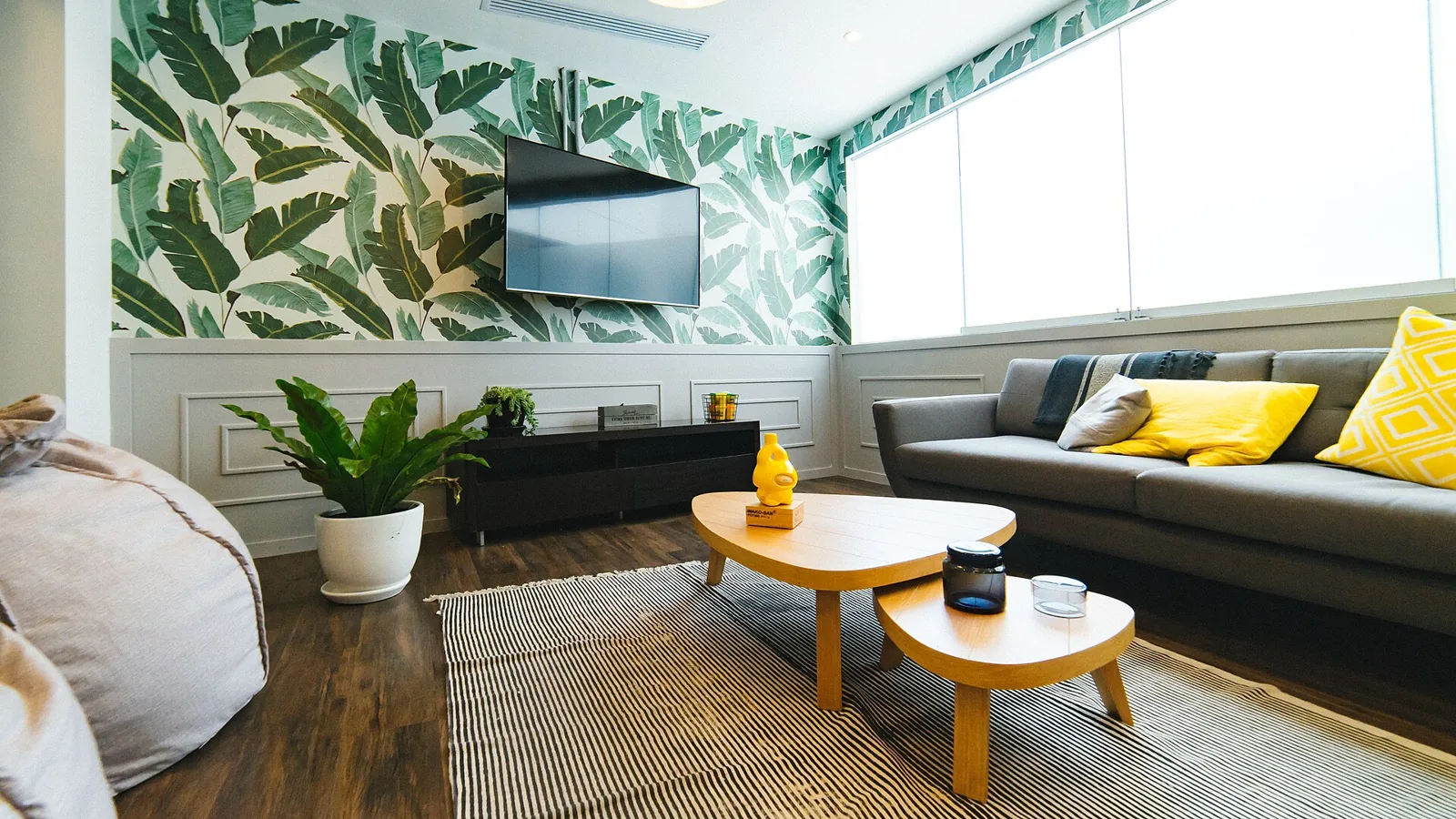 Bright shared workspace with patterned wallpaper and lounge seating.