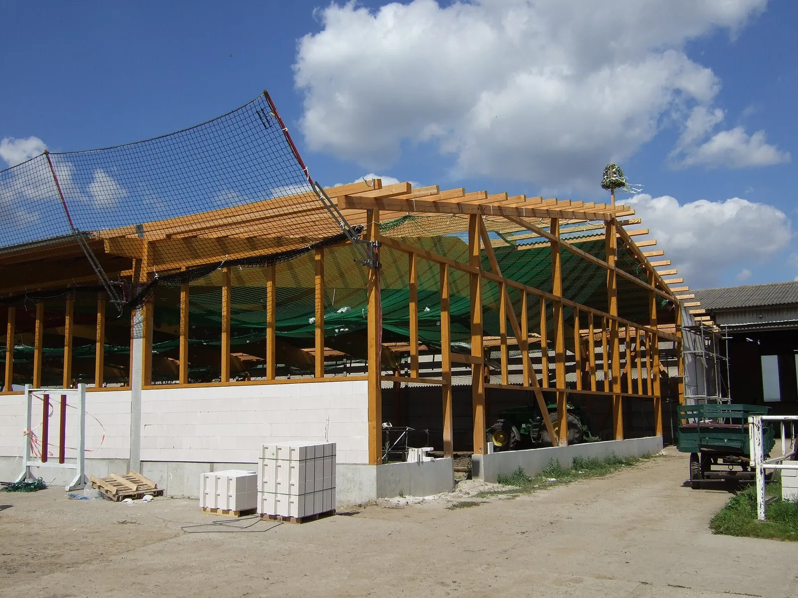 Timber structure above masonry walls during construction.