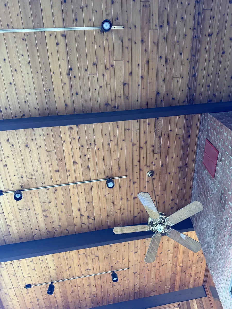 Timber ceiling with exposed beams and a ceiling fan.