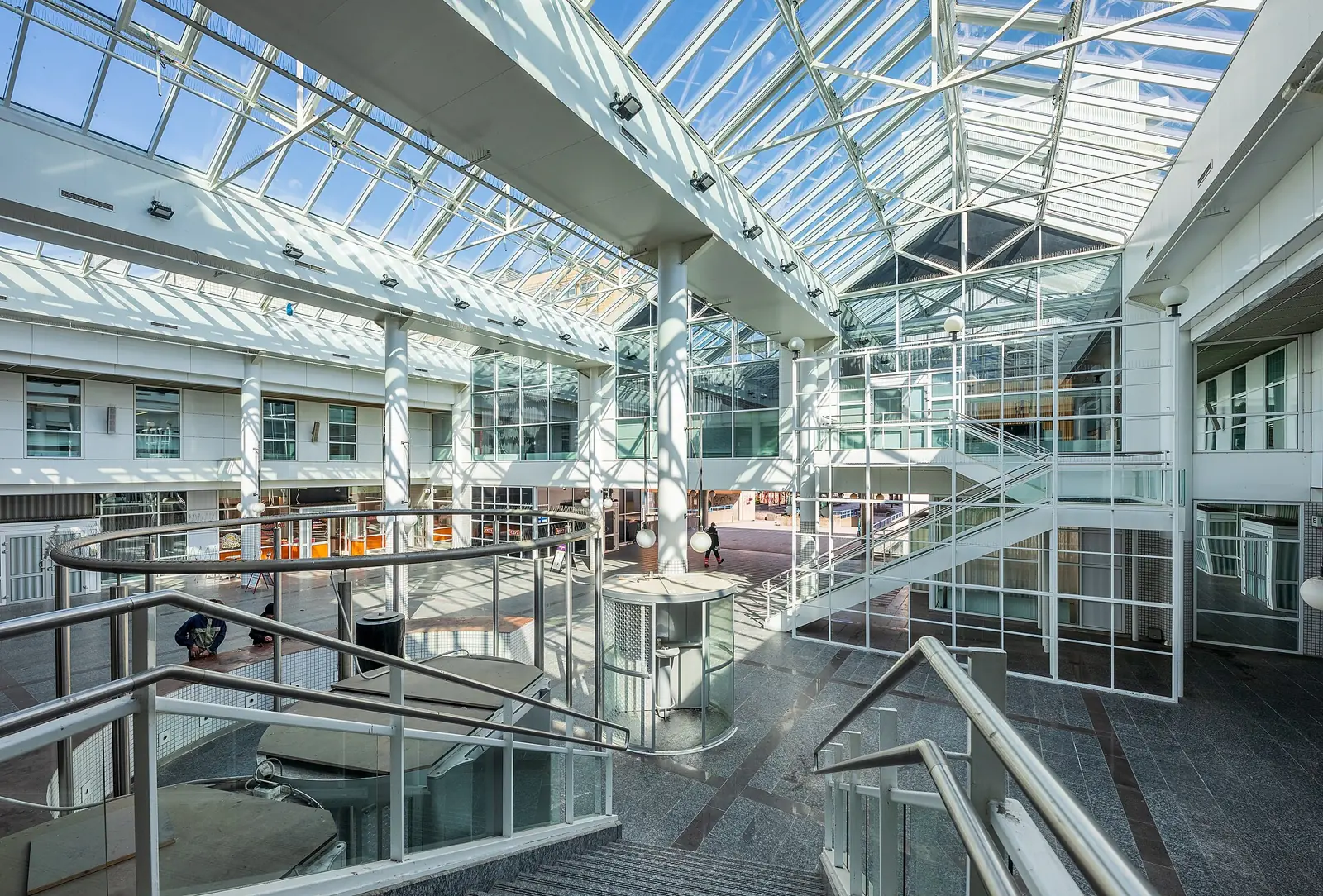 Bright glazed atrium in an office building.